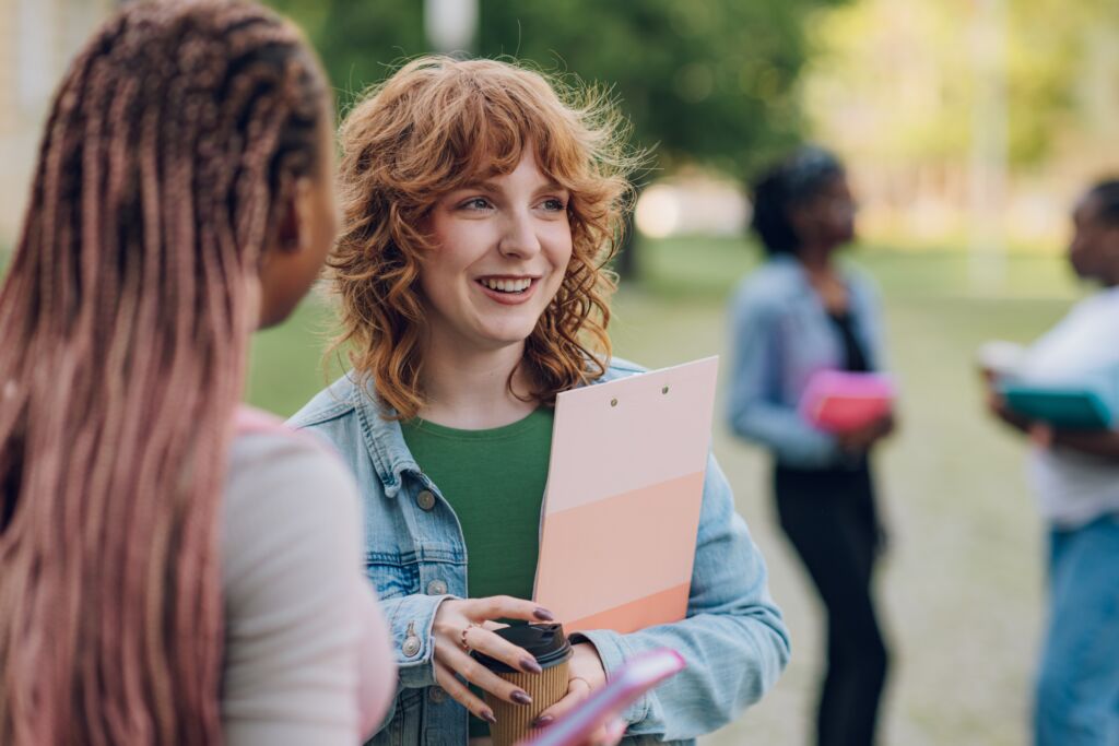 Portrait,Of,Smiling,College,Student,Standing,At,University,Campus,With